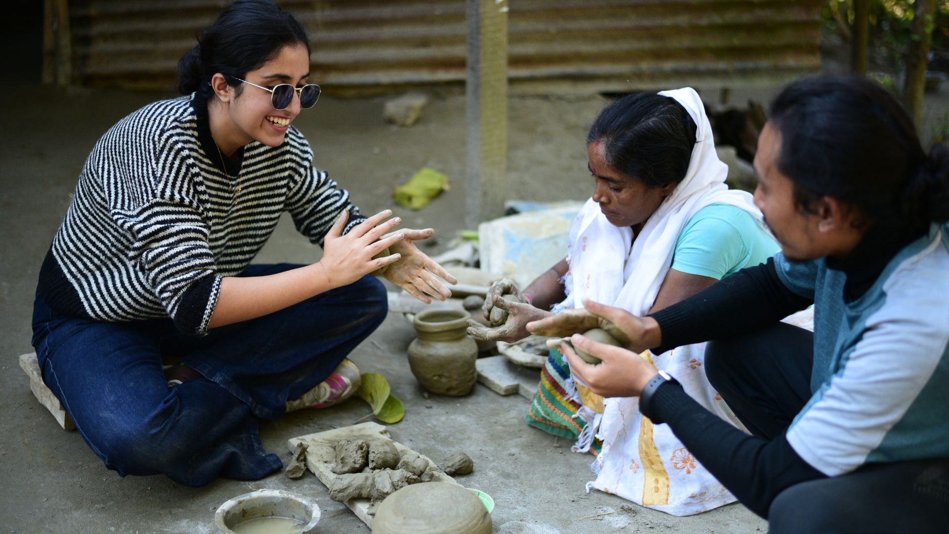 Our guest tries her hands at pottery in Salmora, Majuli