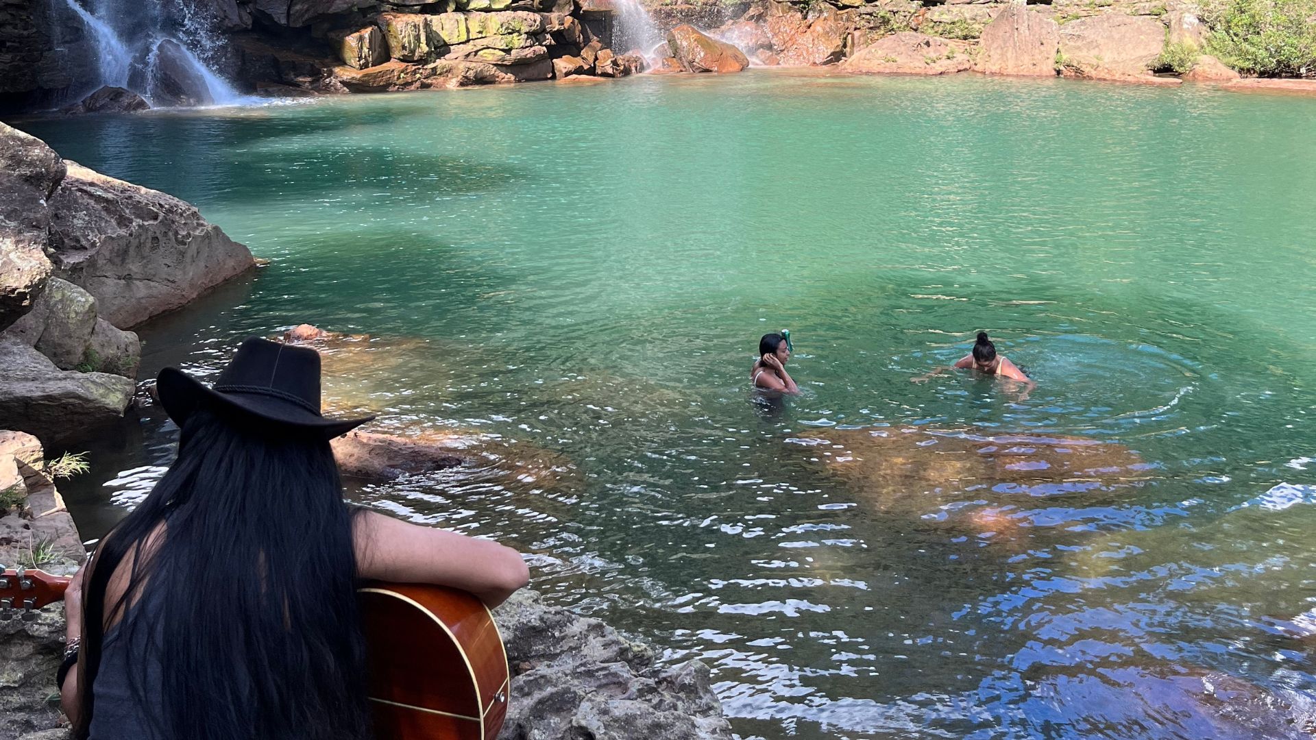 Tenny jamming with guests by waterfall