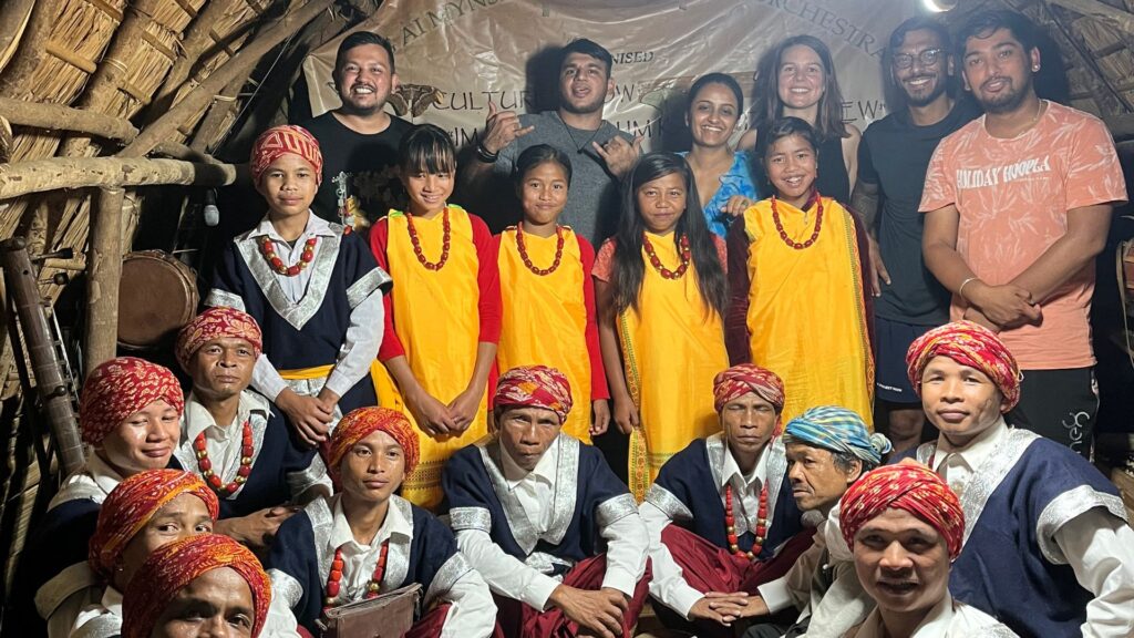 Khasi musicians in traditional attire playing folk instruments.