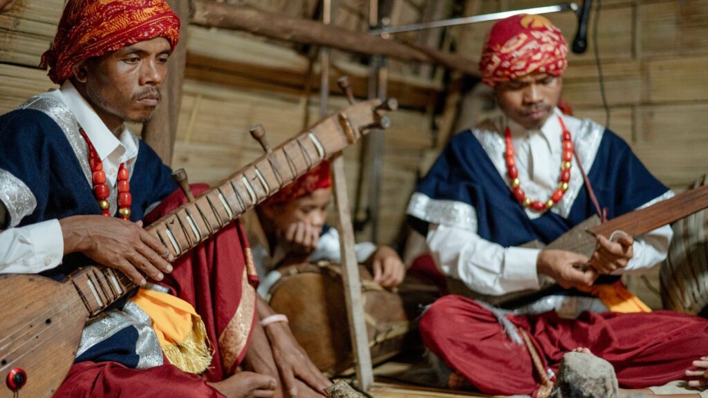 Khasi musicians in traditional attire playing folk instruments.