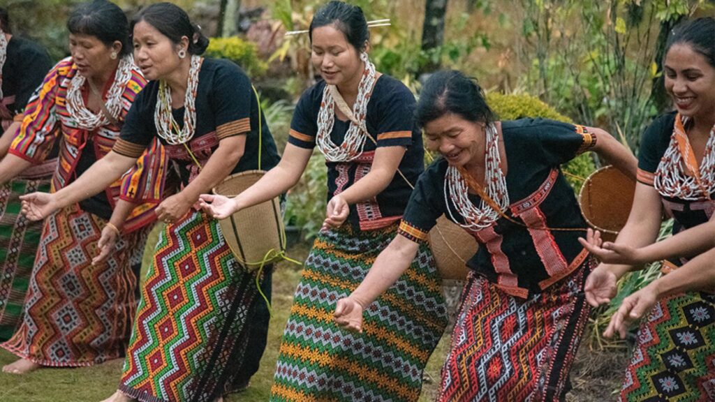 Group of Idu Mishmi women in traditional attire performing a community dance.