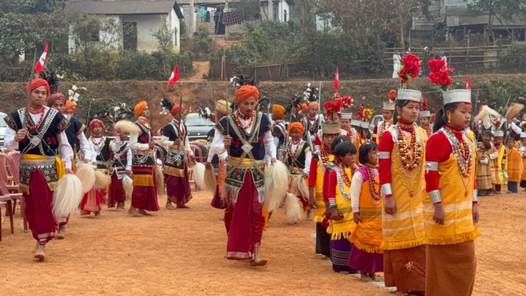 Khasi men and women marching in festival attire.