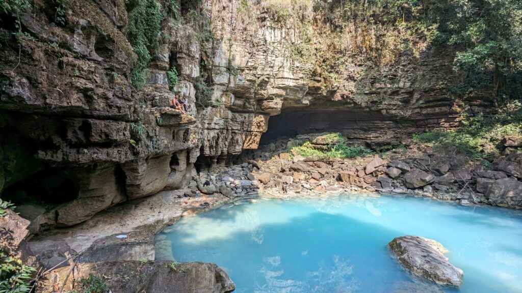 Large cave opening with blue pool