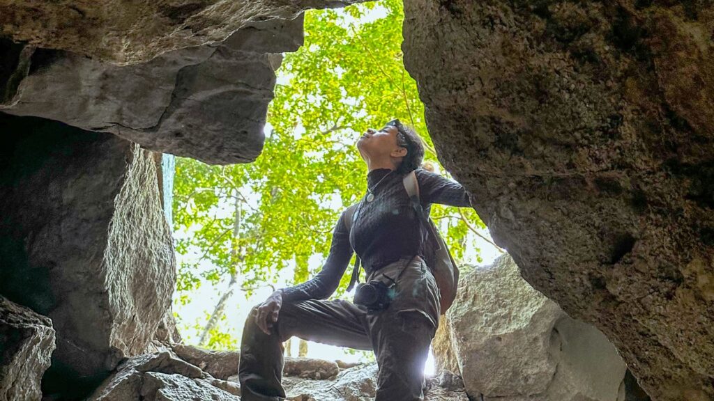 Explorer crossing cave pool