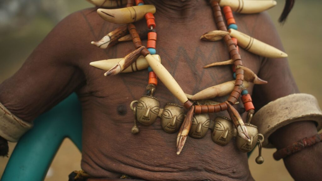 Close-up of Konyak warrior necklace with brass heads.