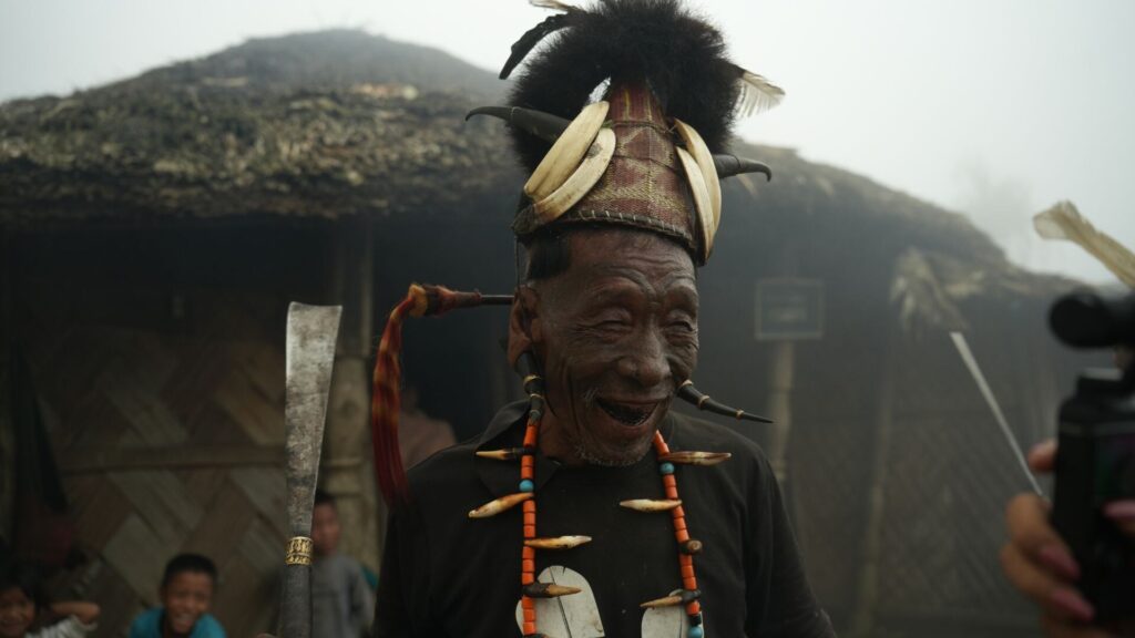 Konyak elder smiling in traditional headgear