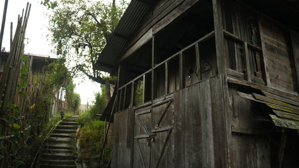 Wooden house beside stairway and trees