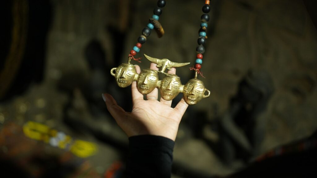 Traditional brass pendant with face motifs