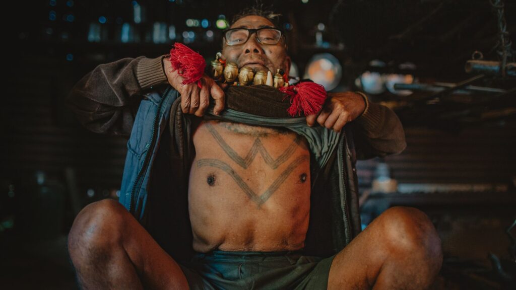 Konyak elder showing traditional chest tattoos