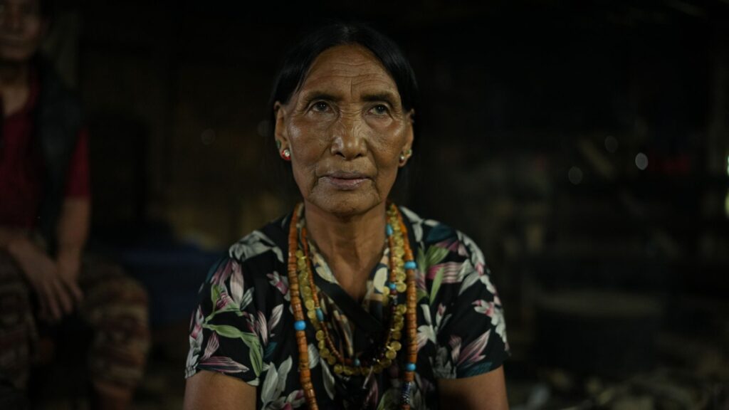 Elderly woman wearing layered bead necklaces