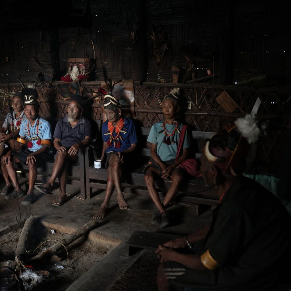 Naga Elders seated inside village home