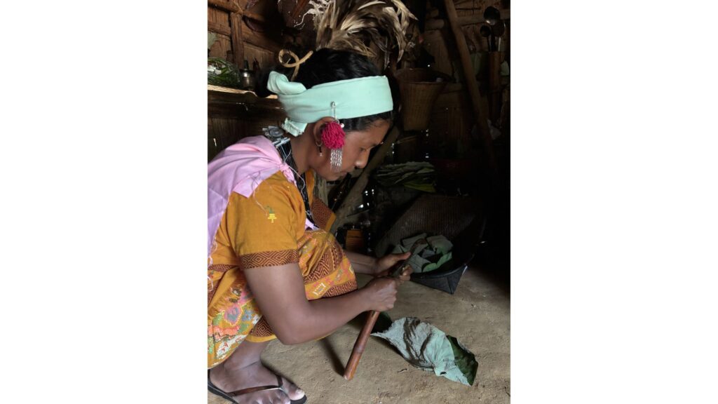 Woman preparing food in a Garo home